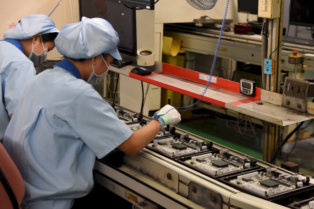 Example of using an anti-static wrist strap when working with PC components: A worker at Gigabyte's motherboard factory